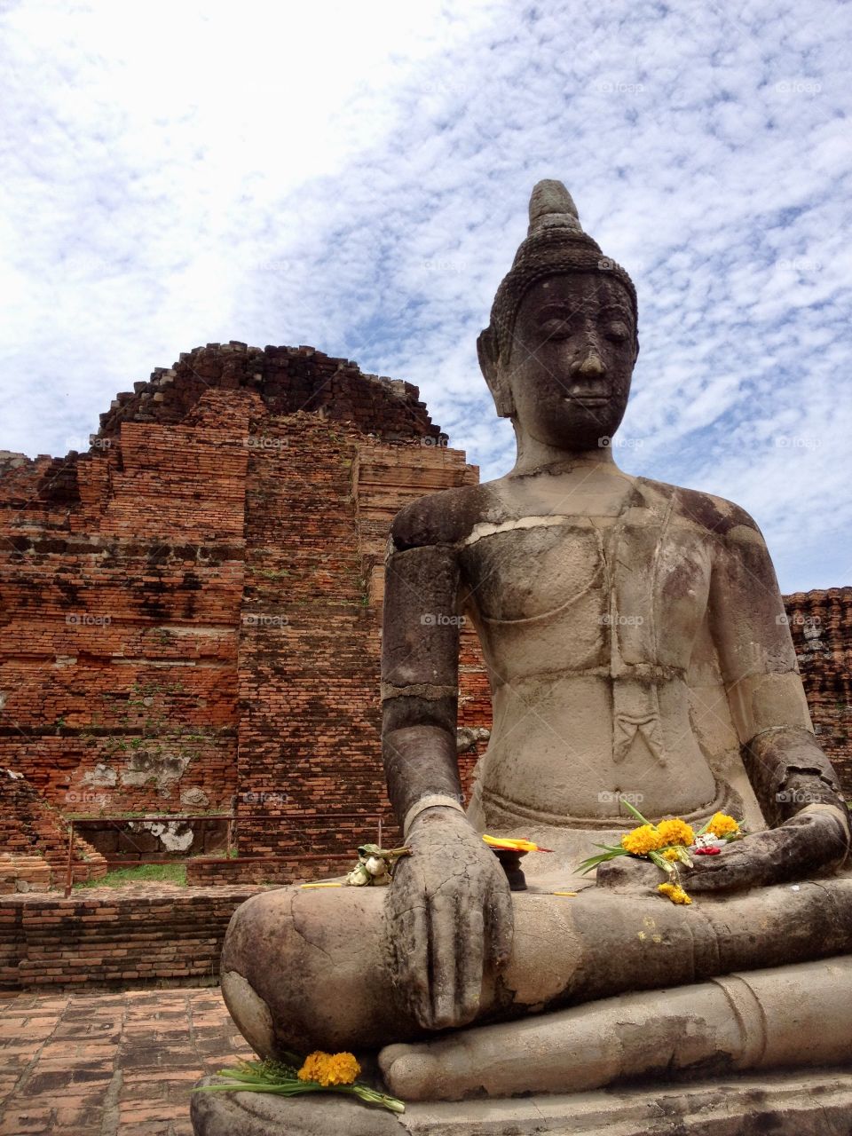 Buddha statue meditates with resolution at Ayutthaya, Thailand