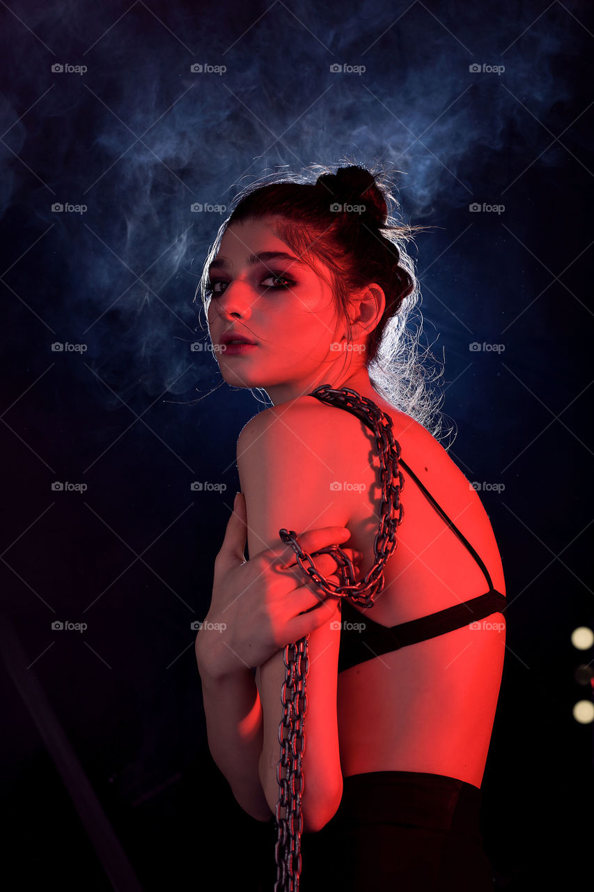 night portrait photo of a young woman with bright and unusual makeup