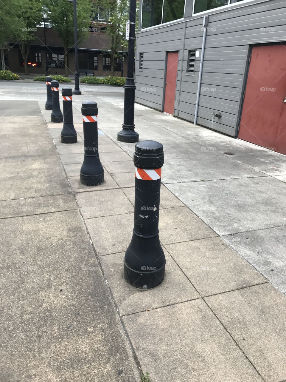 Orange caution stands to prevent cars from running into the building or parking.