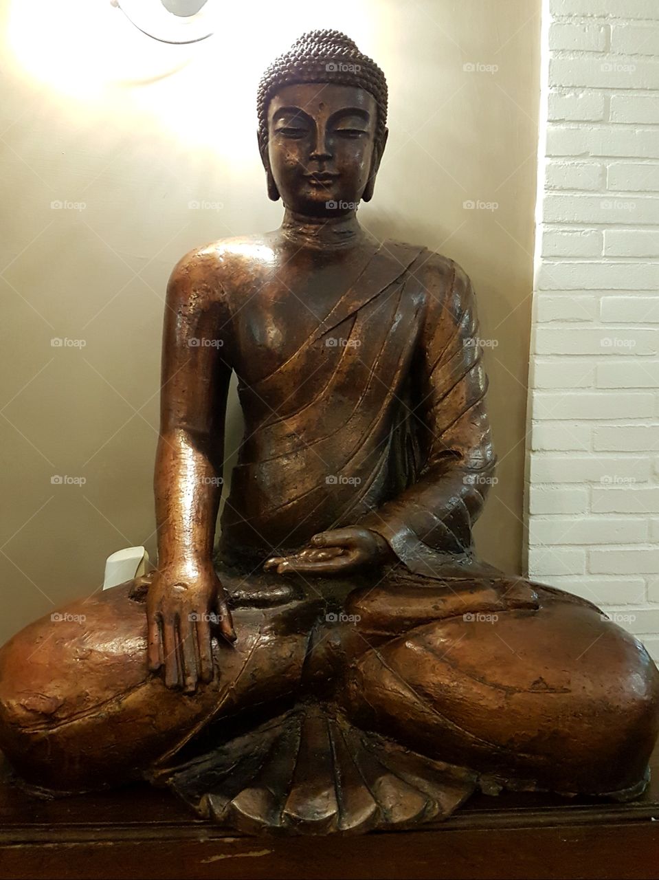 Wood carved statue of Buddha in meditation