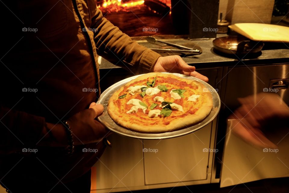 Preparing To Cook A Homemade Pizza With Mozzarella And Spinach In A Wood Fired Oven