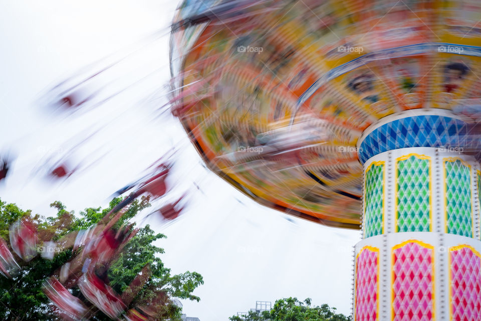 Colorful ride on the amusement park, people were screaming along with the colorful view