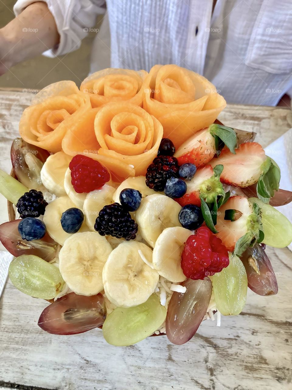 A work of art, a fruit bowl covering chia and coconut milk.