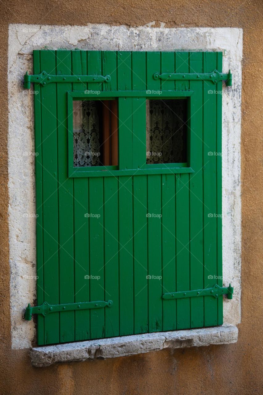 A window with green shutters 