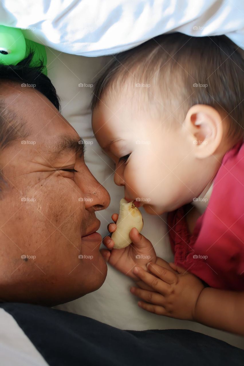 Sleeping dad and his adorable baby