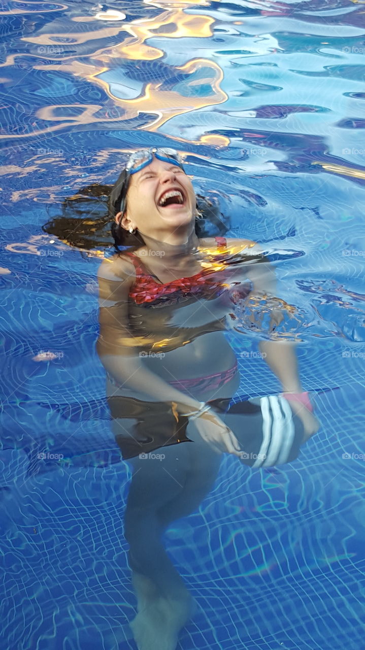 Happy girl in swimming pool