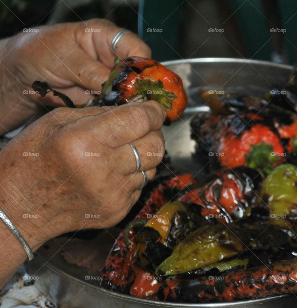 Grandmother peeling peppers