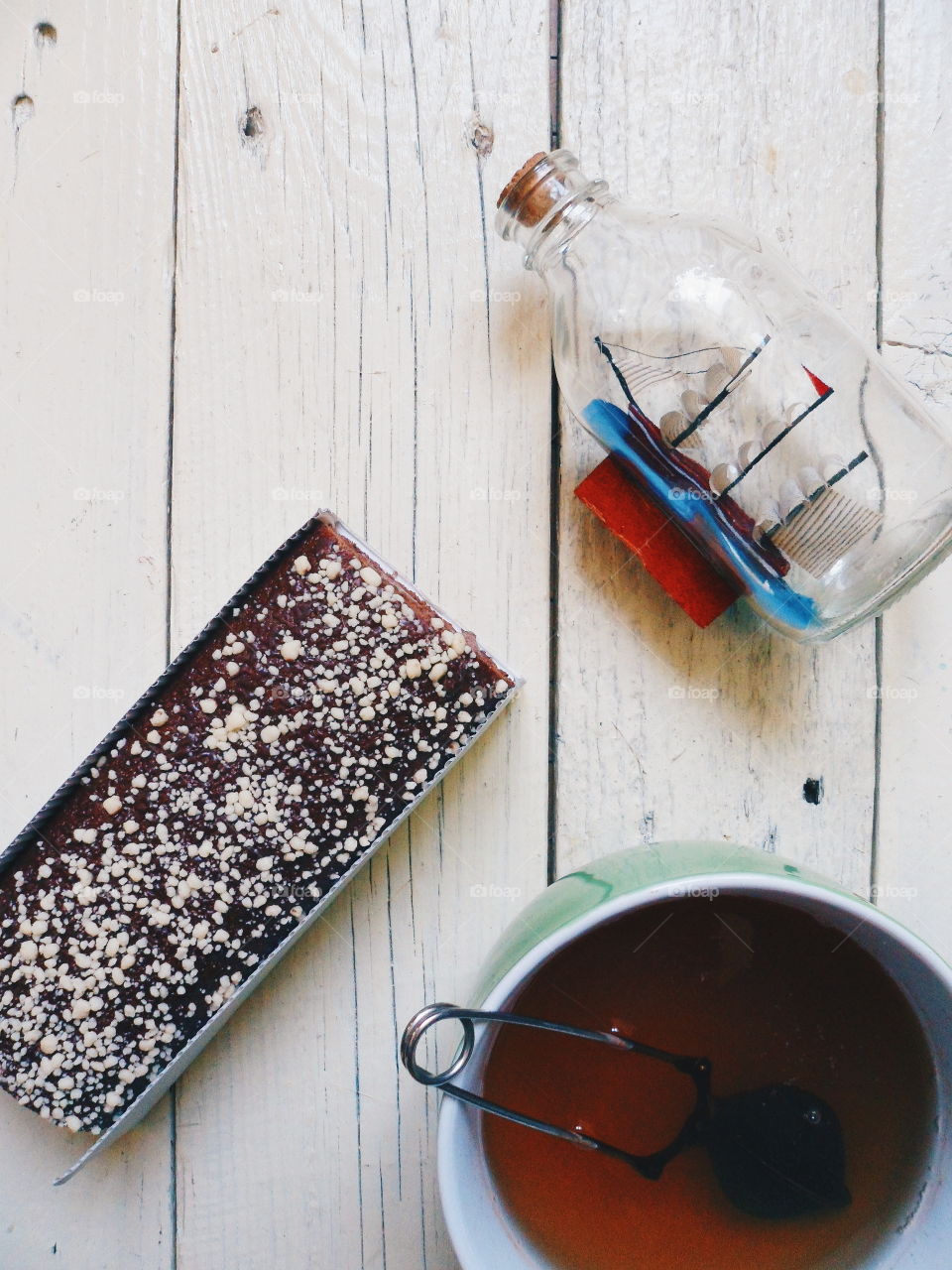 chocolate roll and a cup of black tea on a white background