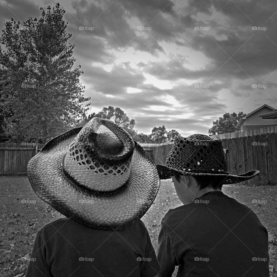 Black and white photo of two kicking cowboys!