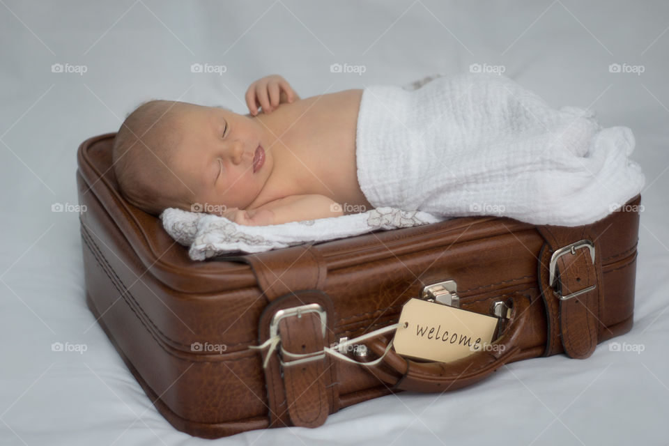 Baby sleeping on briefcase