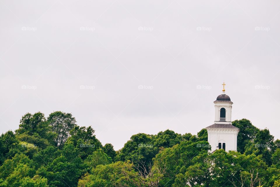 Church tower among tree tops