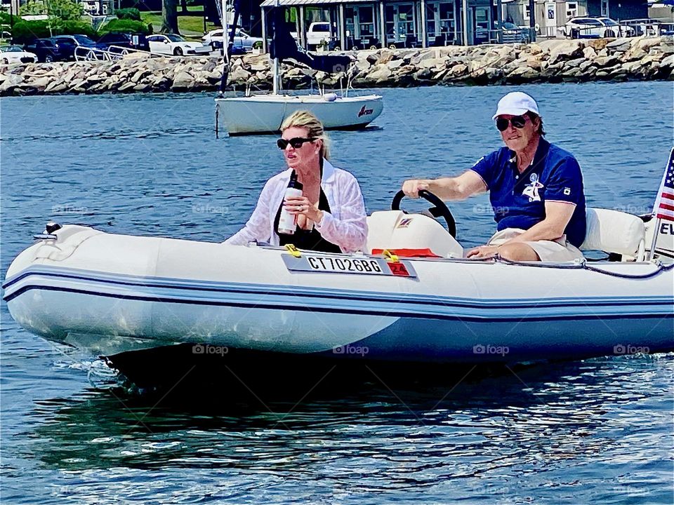 An adventurous couple is motoring their small boat along in the opposite direction towards the “Mamaroneck” marina passing us by on a clear sunny day in July of 2023. Hypnotic Productions