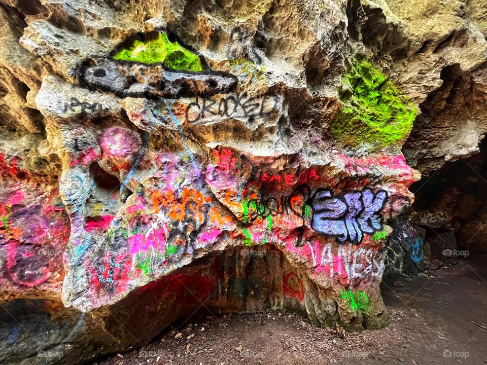 Neon graffiti on a cave wall