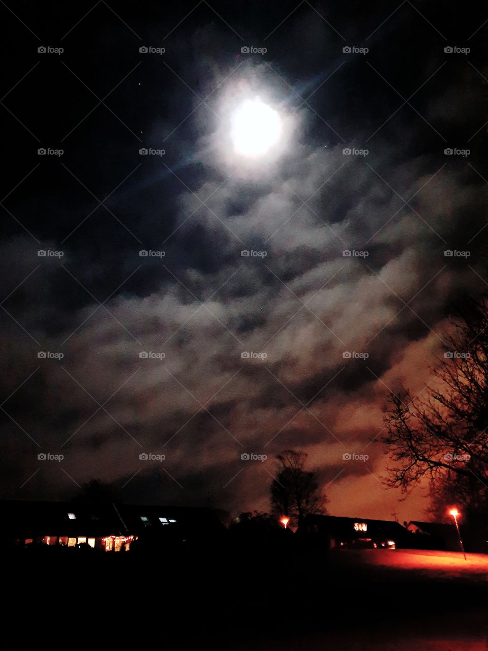 Dramatic moonlit sky over village