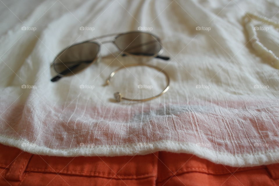 Bracelet and sunglasses on clothes