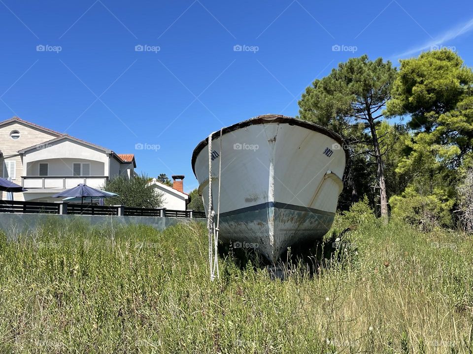A white Boat out of water on Island in Croatia