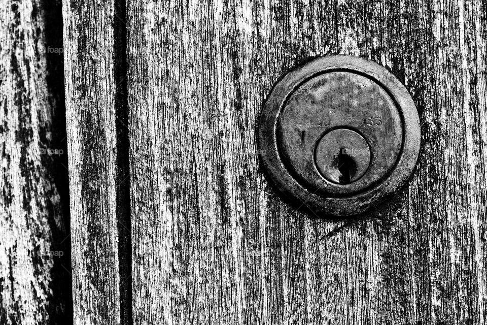 Union Lock. A Union style lock in a vintage wooden door. Black and white image.