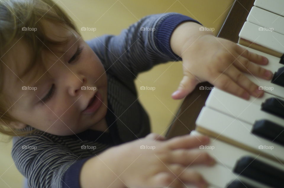 High angle view of a boy playing piano