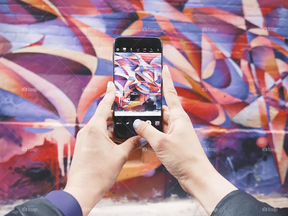 Taking Graffiti Picture
Close up of female hands taking picture of graffiti wall with her smartphone.