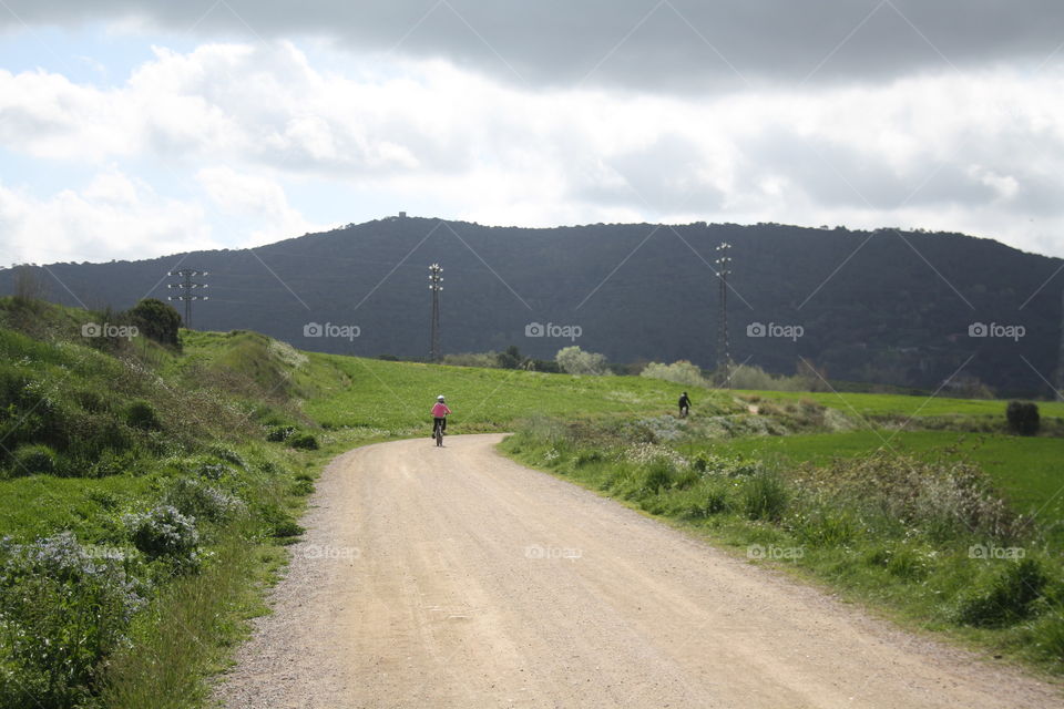 Landscape of mountains and cyclists walking