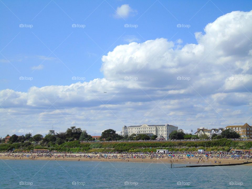 Airplane above beach during Clacton Air Show, UK