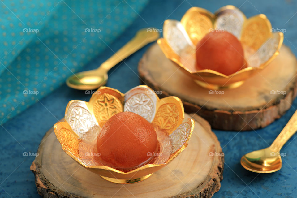 Indian sweet gulab Jamun in a gold silver bowl