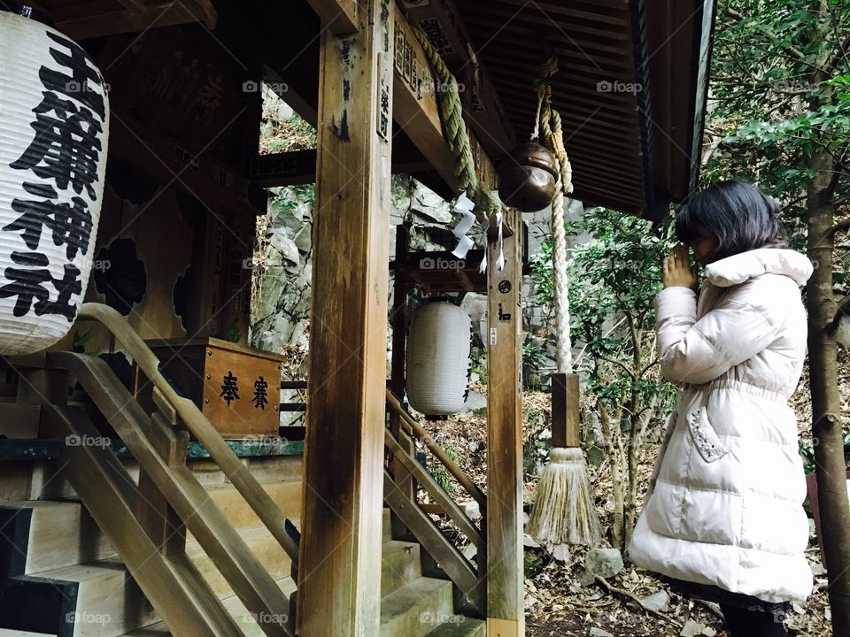 Praying at a Shinto shrine in Hakone, Japan. 