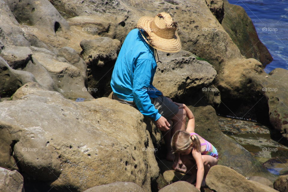 Exploring rocky beach terrain. California coast.