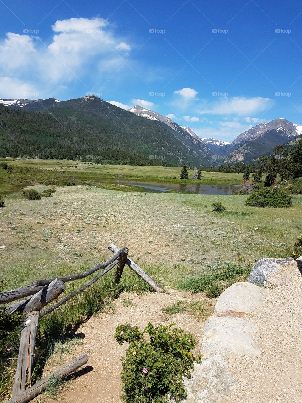 WOODEN FENCING AND MOUNTAINS