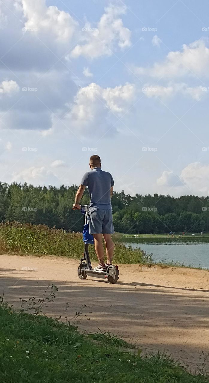 men on a electric scooter, summer time