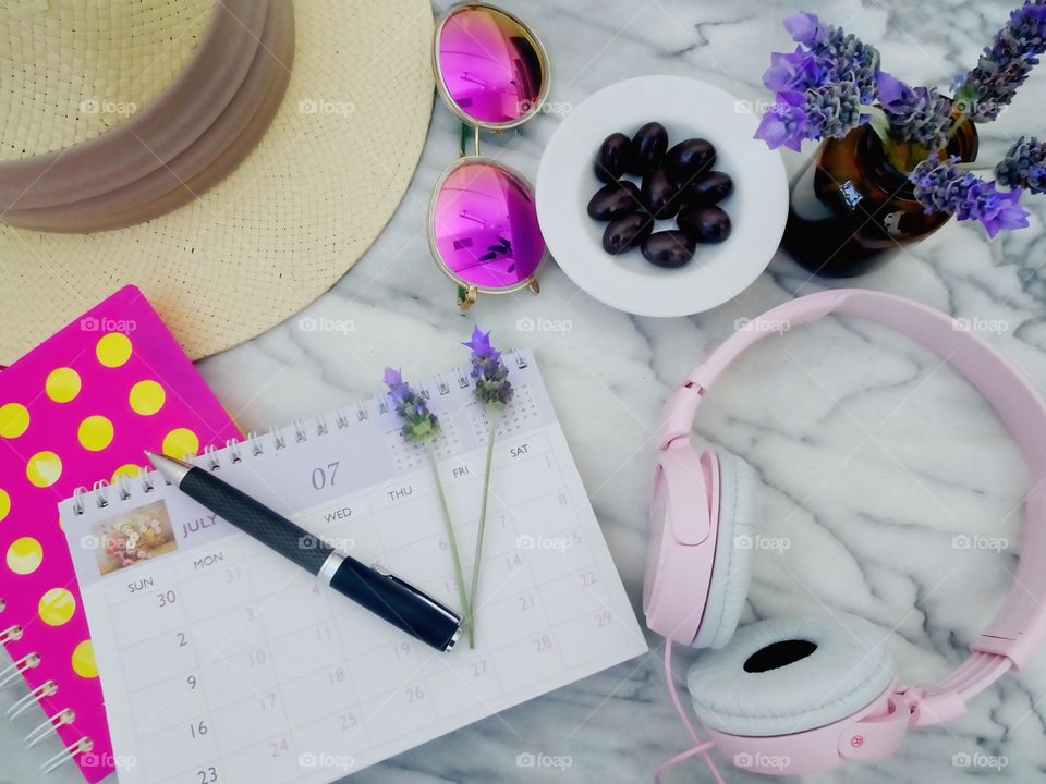Urban essentials. 
Vacation planning, with a calendar and summer essential accessories. 