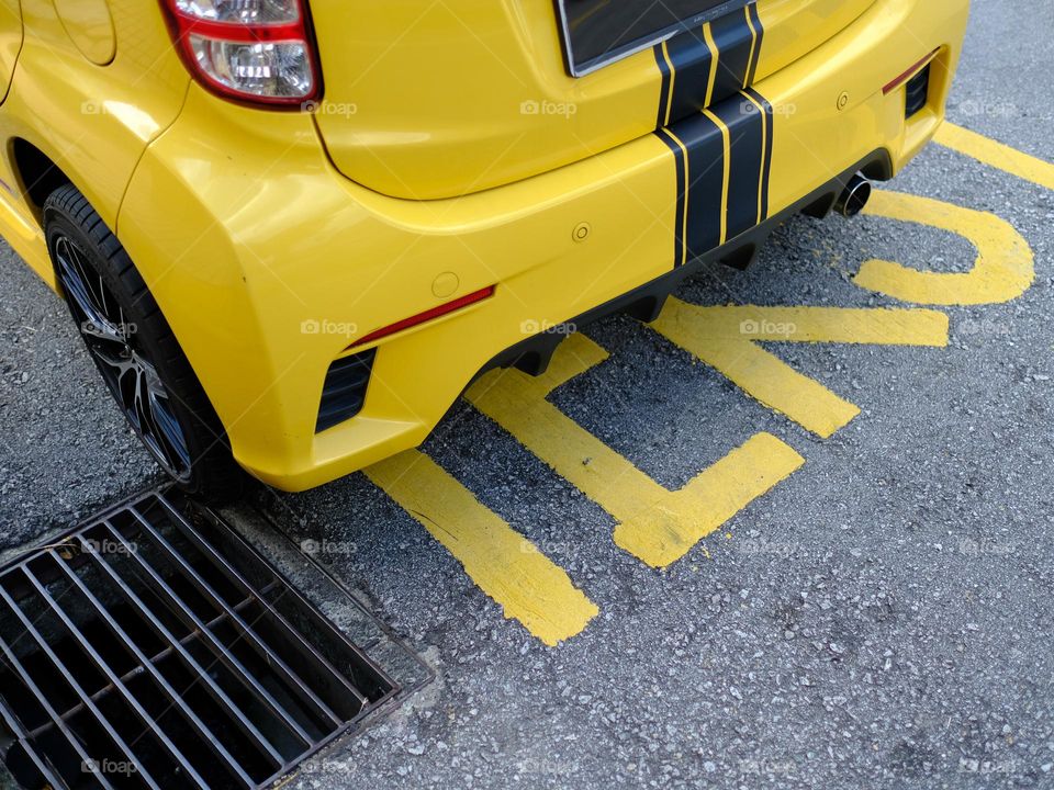 Yellow car and taxi text signage