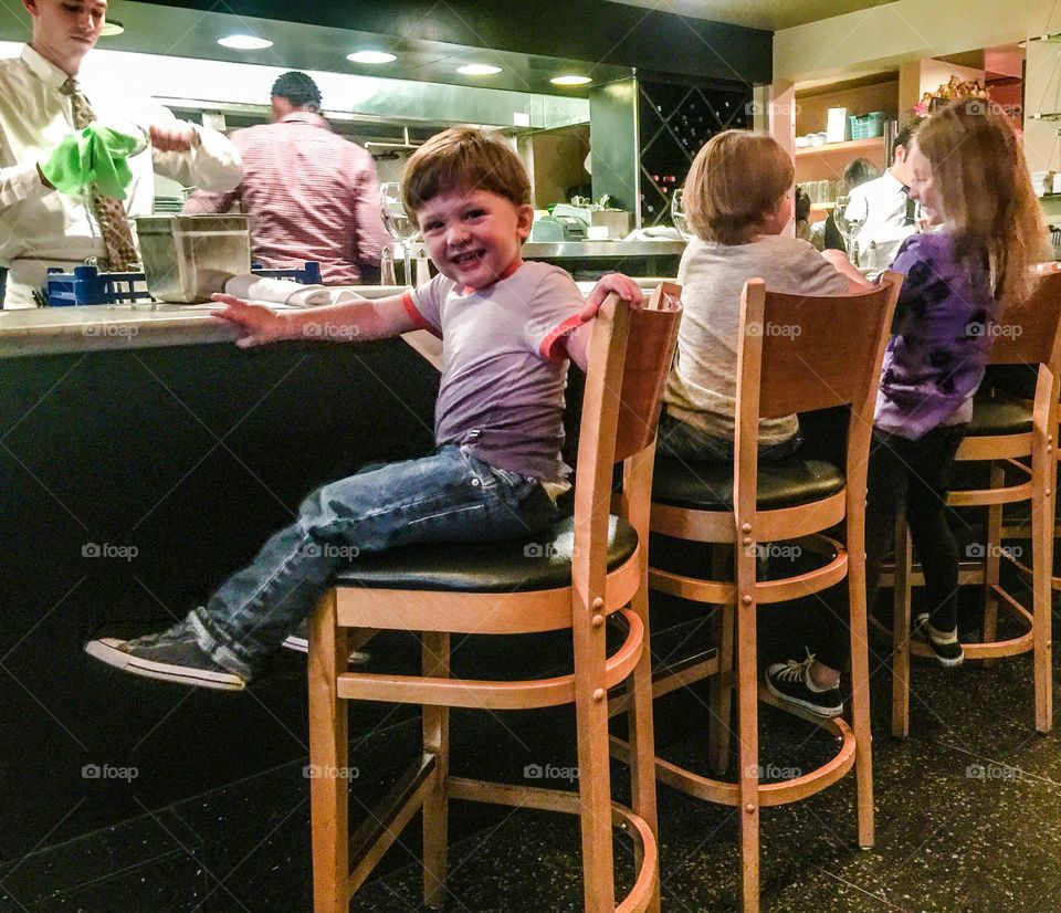 Children sitting on chair in restaurant