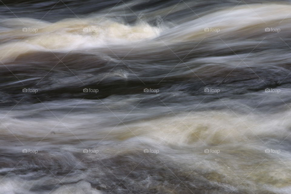 Water abstract slow motion blur rushing river water 
