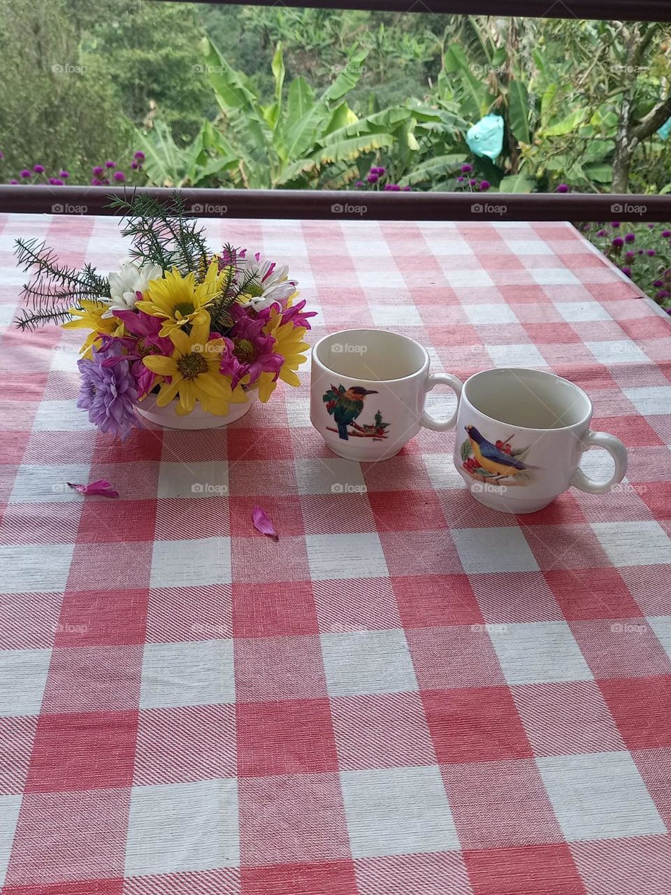 flower arrangement with two caps on a table