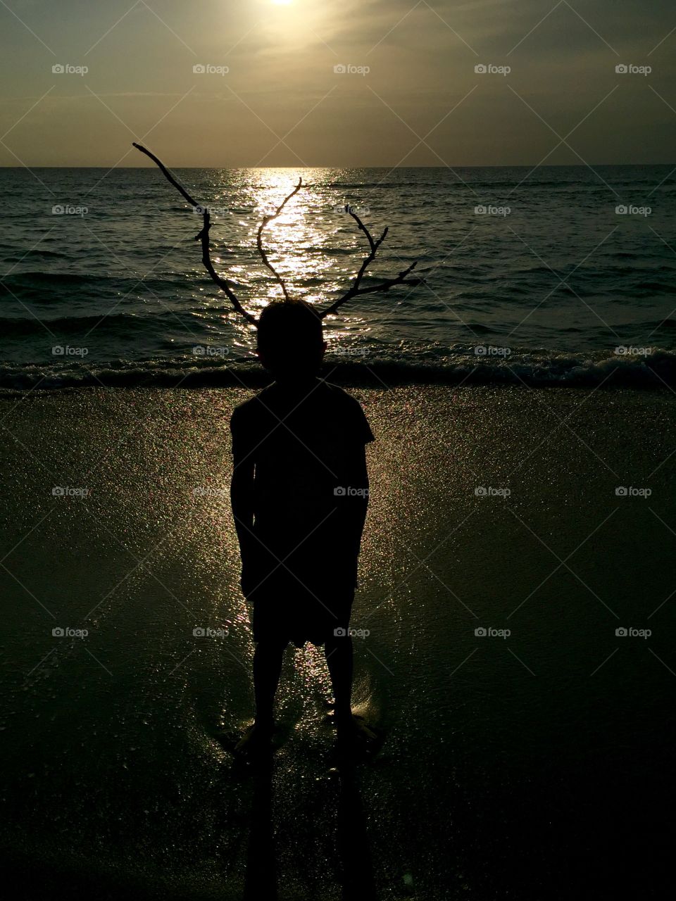 This was captured early sunrise at Oceanridge as a child played with branch that washed ashore and by using his own imagination.