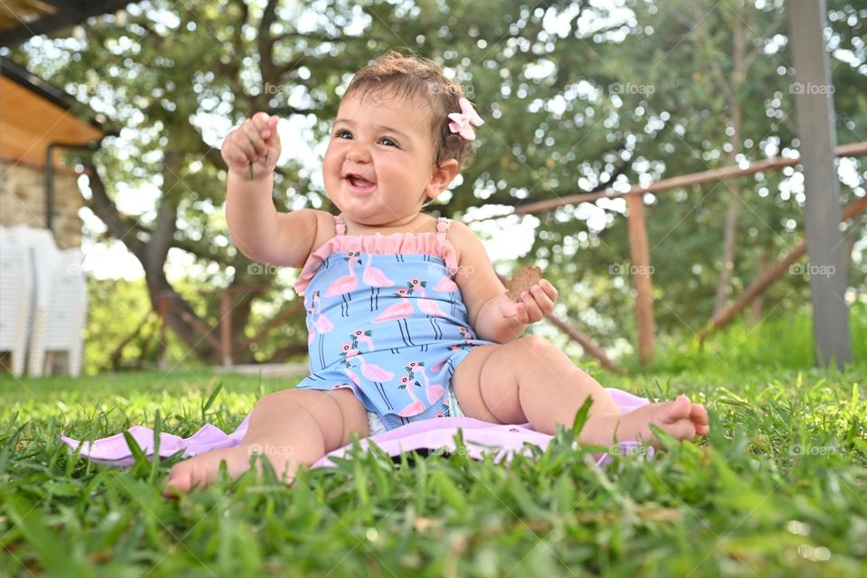 little girl with swimsuit on the lawn