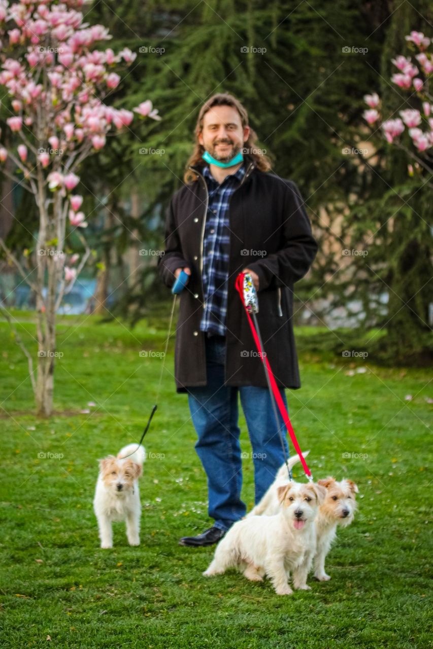 Portrait of a man in nature with puppies