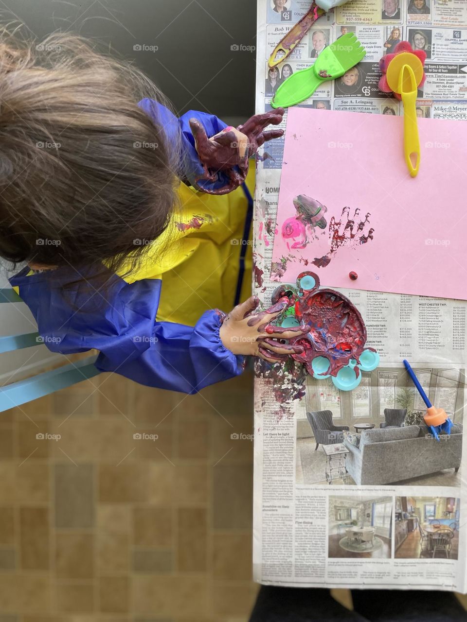 Toddler girl finger paints, toddler gets messy, making a mess with paints, crafts with kids, making a mess with crafting, children making messes 