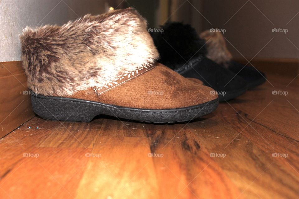 Faux fur Slippers lined up in the hall
