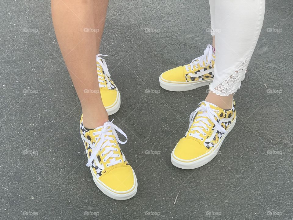 Best friends matching bright yellow shoes 