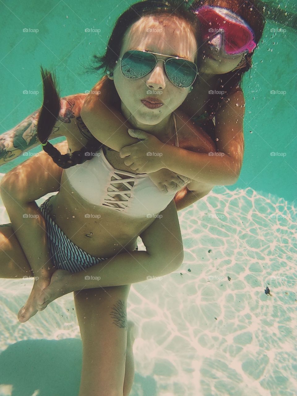 Mother and daughter underwater