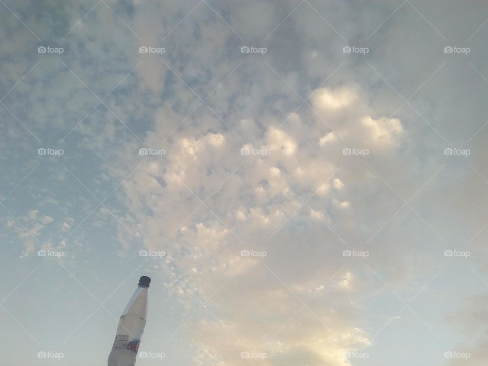 Scenic sky and a bottle embraces high sky.