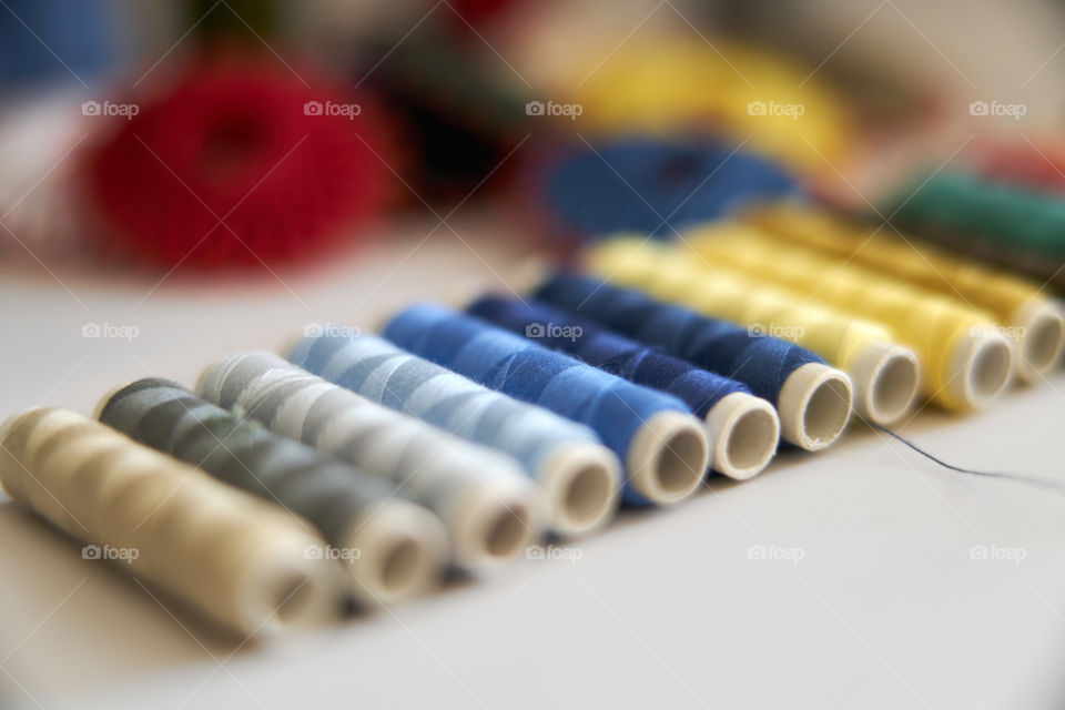 Multicolored spools arranged in a row