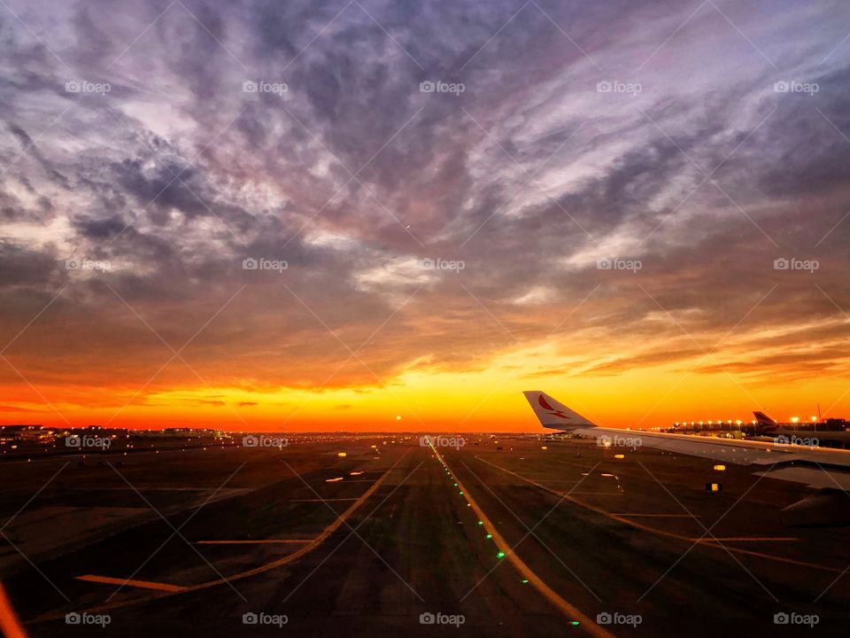 Sunrise in the runway for landing seen through the window of the plane, after landing in São Paulo / Guarulhos, while the plane was taxing.