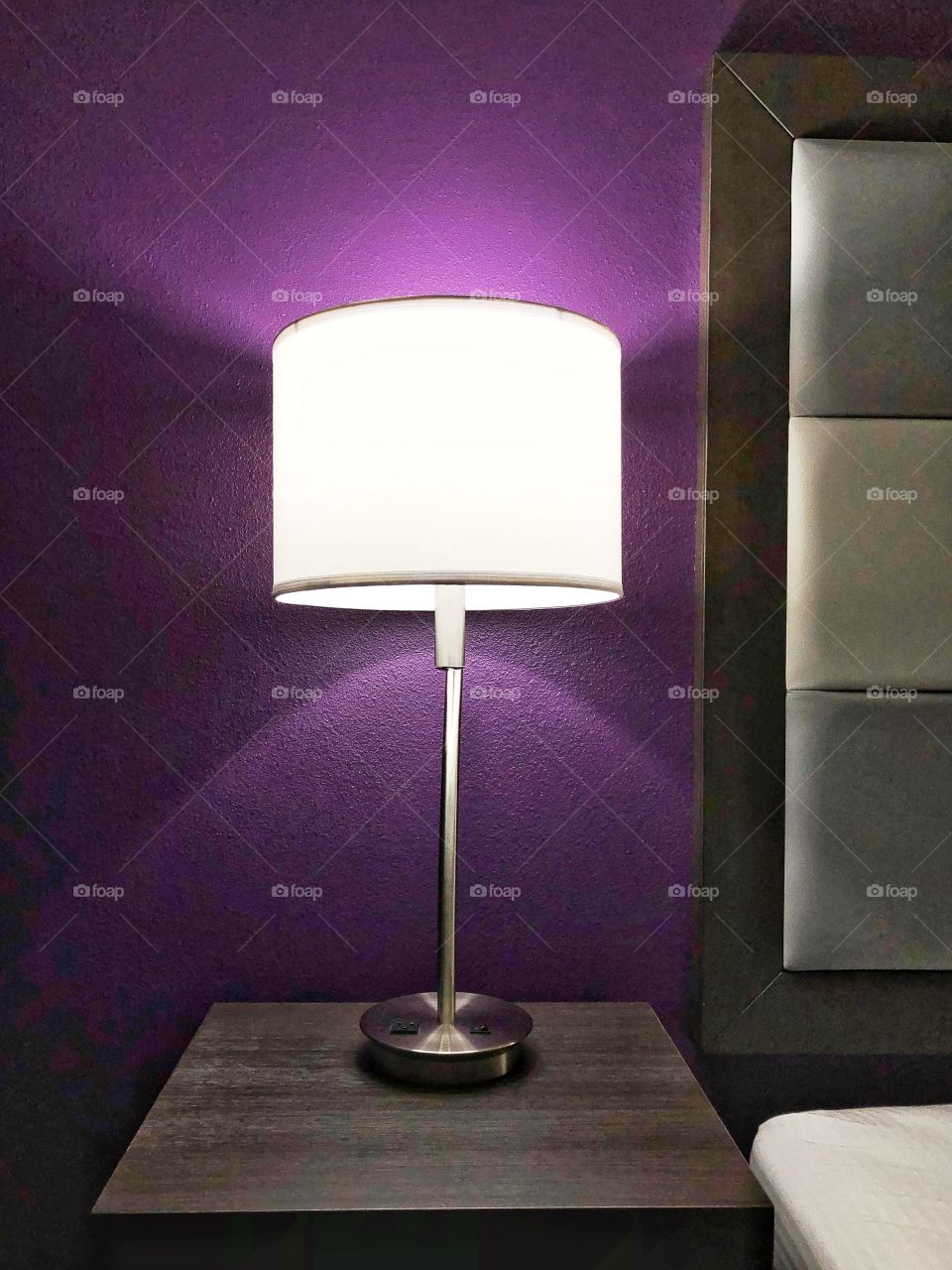 Bright lamp at room with purple walls
