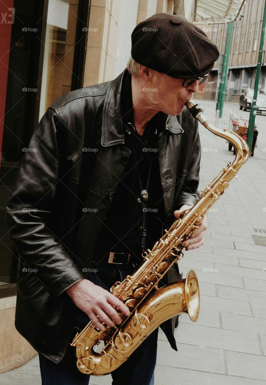 The man who plays  the saxophone on the street