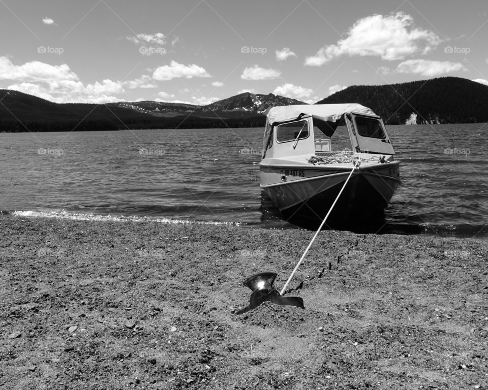 Boat tied to bollard at sea