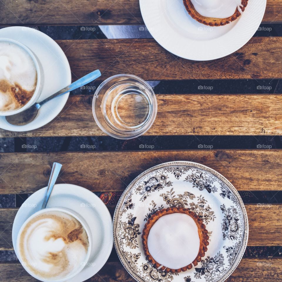 Tableware, cappuccino and cakes 