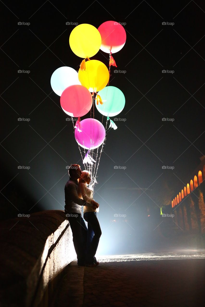 Couple holding Colorful balloons